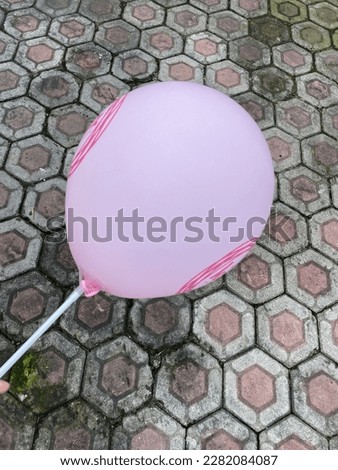 A cheap red balloon with a big round shape