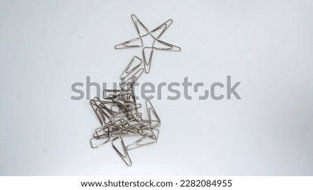 A star from a paper clip and a bunch of paper clips