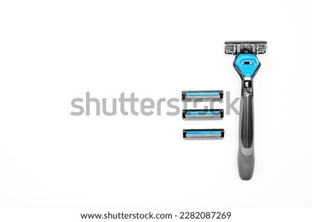 reusable razor with replaceable blades, for men, close-up on a white background, top view, empty space to insert text Royalty-Free Stock Photo #2282087269