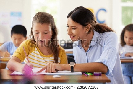 Teacher, learning and helping girl in classroom for writing, studying or assessment. Teaching, development and kid or student with happy woman for education assistance with notebook in kindergarten. Royalty-Free Stock Photo #2282092209