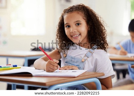 Learning, drawing and portrait of girl in classroom exam, education or studying with book. Preschool smile, development and happy kid or student coloring for creative art in notebook in kindergarten. Royalty-Free Stock Photo #2282092215