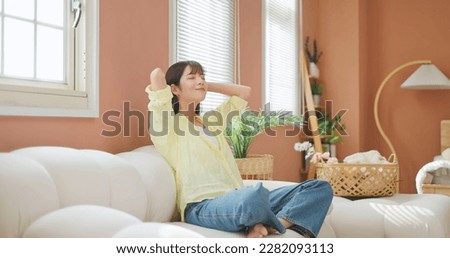 asian girl relieve herself with deep breath hands stretching cross legged and meditation peaceful in mind feels so happy Royalty-Free Stock Photo #2282093113