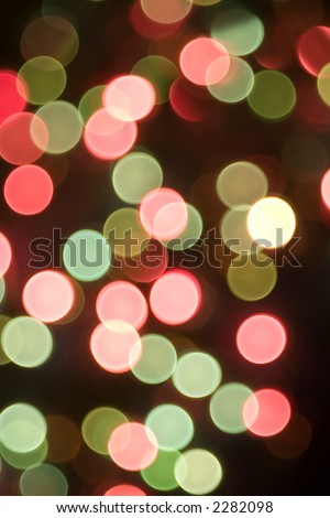 Brightly colored Christmas lights on a Christmas tree. Forced out of focus.