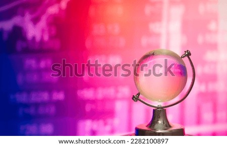 World economy themes.Number or graph of stock on globe cystalball.