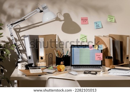 messy office workspace. Messy and cluttered office desk. Messy business office with piles of files and disorganized clutter. Royalty-Free Stock Photo #2282101013