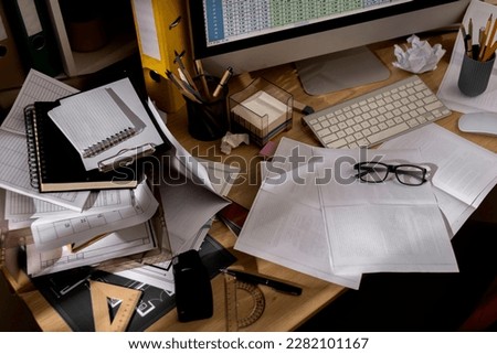 messy office workspace. Messy and cluttered office desk. Messy business office with piles of files and disorganized clutter. Royalty-Free Stock Photo #2282101167