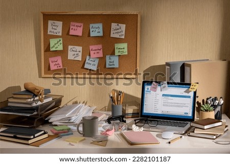 messy office workspace. Messy and cluttered office desk. Messy business office with piles of files and disorganized clutter. Royalty-Free Stock Photo #2282101187