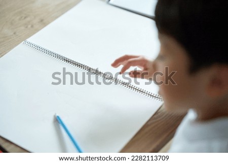 Child drawing on white drawing paper