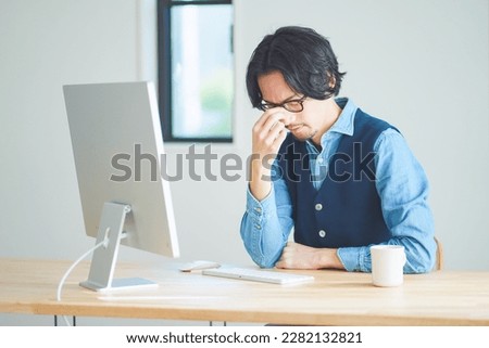 Men with tired eyes from computer work Royalty-Free Stock Photo #2282132821