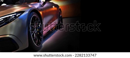 Front headlights of sport roadster  car on black background,copy space	 Royalty-Free Stock Photo #2282133747