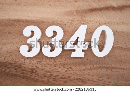 White number 3340 on a brown and light brown wooden background.