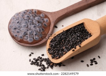 Ocimum is a genus of aromatic annual and perennial herbs and shrubs in the family Lamiaceae. Basil seeds in a wooden spoon. Selasih.  Royalty-Free Stock Photo #2282149579