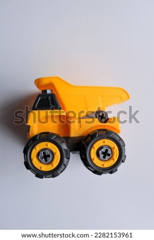 The Close Up and Isolated  Yellow Miner Toy's Car  with white background.