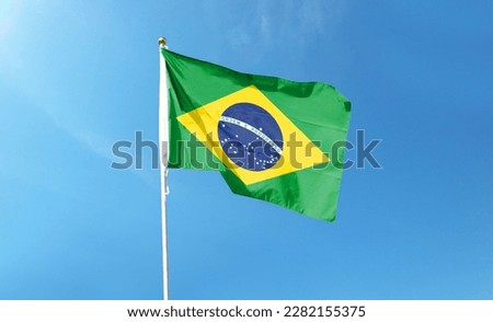 Brazilian flag in the cloudy sky. waving in the sky Royalty-Free Stock Photo #2282155375