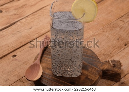 basil seeds in a wooden spoon and a glass of basil water. selasih.
 Royalty-Free Stock Photo #2282156463