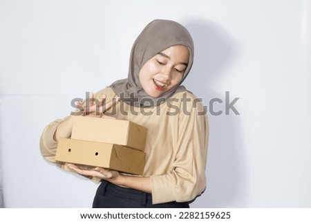 Asian woman with gift box, portrait of happy smiling girl holding surprise present