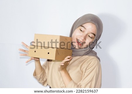 Asian woman with gift box, portrait of happy smiling girl holding surprise present