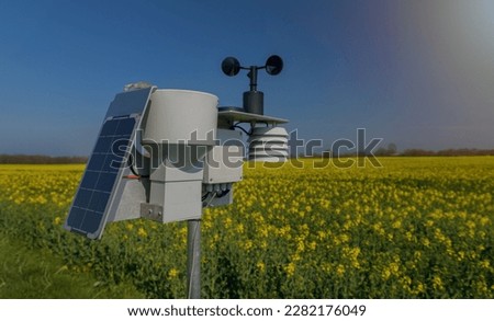 A scoring station stands in the middle of a vast yellow field surrounded by golden grain and fragrant flowers. The sun shines brightly in the sky and the warm rays make the landscape shine. Royalty-Free Stock Photo #2282176049