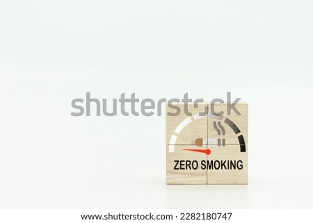 Wooden cubes with zero smoking icons on white background.Gauge arrow set to zero.Zero smoking.World No Tobacco Day. No Smoking Day Awareness.