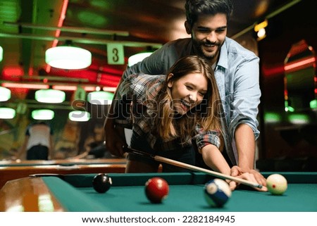 Couple dating, flirting and playing billiard in a pub Royalty-Free Stock Photo #2282184945