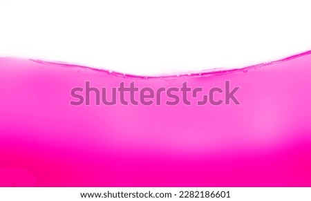 Drink clean pink water in a glass and the bubbles look like splashes and waves.	