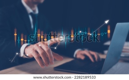 investment financial and saving concept, businessman working on table with computer laptop and  virtual trading graph, business growth and investment strategy. stock market trading, economy exchange