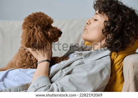 Woman hugging and loving her dog Royalty-Free Stock Photo #2282192069