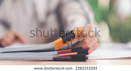 business accounting documents ,auditor ,management and auditing of office documents ,Reports for Tax Time Analysis ,office worker working with document folder ,Management of corporate data storage Royalty-Free Stock Photo #2282192203