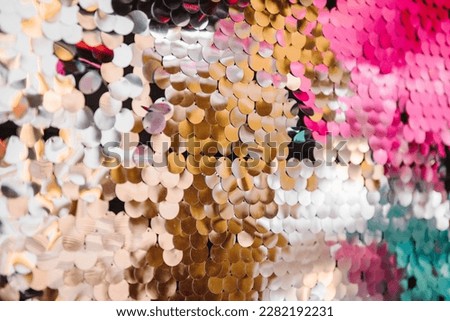 Background with colored glitters. Silver photo booth with decor shiny for party time. Zone with sparkling sequins. Festive wall for wedding. Place for congratulations on birthday. Happy New Year 2024.