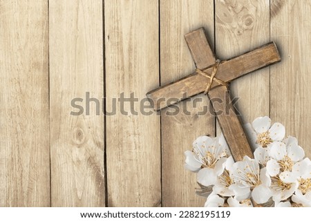 Easter wooden cross with fresh flowers