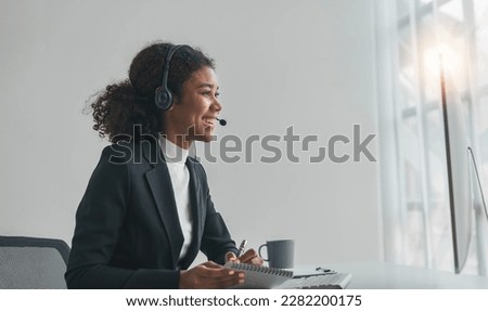 close up call center operator in wireless headset talking with customer, woman in headphones with microphone consulting client on phone in customer support service, looking at computer screen Royalty-Free Stock Photo #2282200175