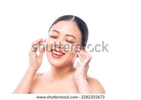 Beautiful attractive asian woman smile in bathrobe white towel after shower. touch her face for hair spa and skin care concept isolated in studio white background with copy space