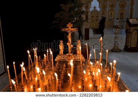 Panakhida, Easter, funeral liturgy in the Orthodox Church. Christians light candles in front of an Orthodox cross with a crucifix and sacrificial bread. The concept of the Orthodox faith and religion
