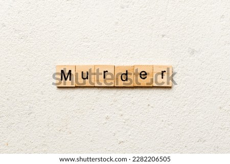 murder word written on wood block. murder text on table, concept.