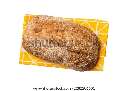 Freshly baked delicious french bread with napkin isolated on white background top view. Healthy white bread loaf.
