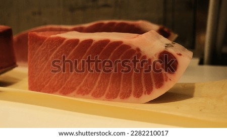 The photo showcases the stunning and appetizing texture of bluefin tuna sashimi in a deep red color. Its presentation is both elegant and inviting, promising a delicious culinary experience.