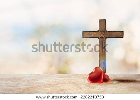 Red heart and Christian wooden cross