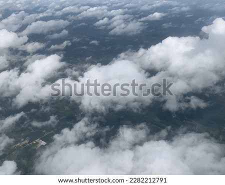 High-angle photo from an airplane, White Stratocumulus clouds float like cotton wool above the beautiful sky at Trang, Thailand.no focus Royalty-Free Stock Photo #2282212791