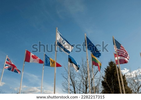 flags of European countries against the background of the blue sky are flooding in the wind
