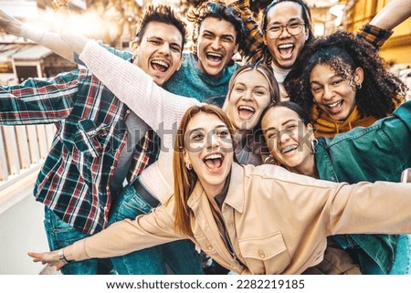 Multiracial young people smiling together at camera - Happy friends having fun hanging on city street - Friendship concept with guys and girls enjoying summer holidays - Bright filter