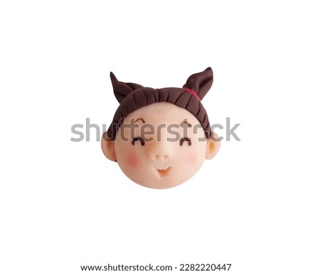 A girl's smiling face(This is a photo of a clay work)