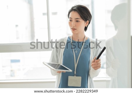 Two women presenting in an office Royalty-Free Stock Photo #2282229349