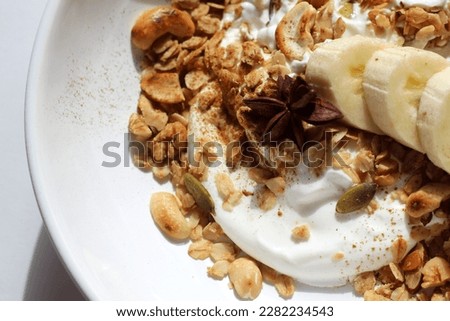 Low-fat Greek Yogurt with Homemade Granola, Nuts, Banana. Eating Healthy Breakfast.