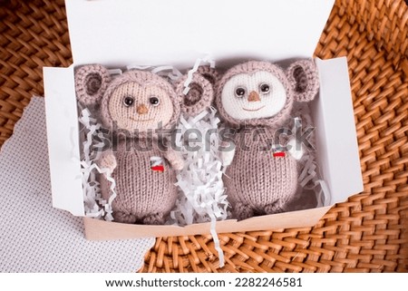 knitted brown Russian toy cheburashka with oranges. Handmade by hand made Royalty-Free Stock Photo #2282246581