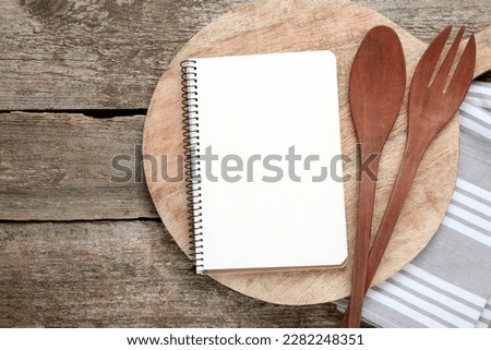 Blank recipe book and kitchen utensils on old wooden table, flat lay. Space for text Royalty-Free Stock Photo #2282248351