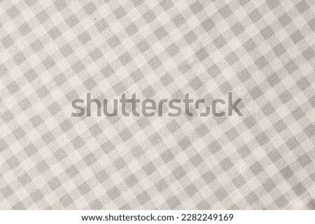 Beige checkered tablecloth as background, top view Royalty-Free Stock Photo #2282249169
