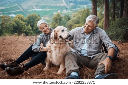 Dog petting, hiking and a couple in nature for travel, relaxation and break on a mountain. Happy, relax and an elderly man and woman with an animal on a walk in the mountains and resting together