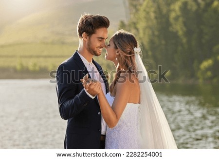 Wedding, dance and couple love by lake with care and support from marriage together by water. Nature, happiness and holding hands of young people with a happy smile from trust and commitment event Royalty-Free Stock Photo #2282254001