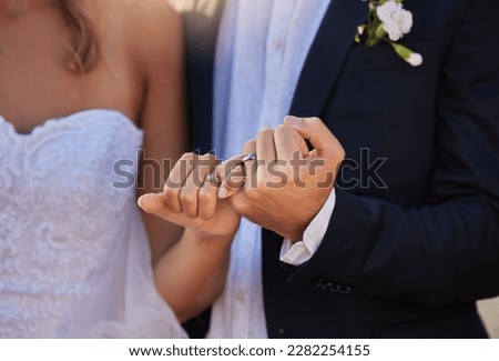 Wedding, rings and closeup of a couple with a pinky promise for love, loyalty and marriage. Romance, hands and married man and woman with jewellery for their union and bond at a romantic event.