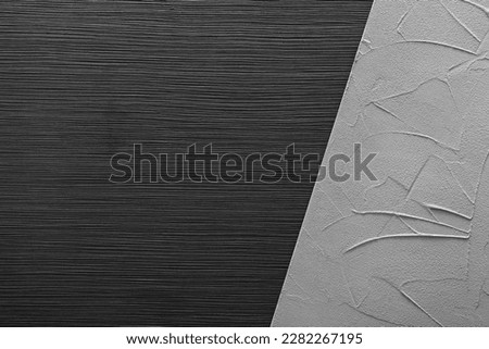 Black wooden and light gray textured surfaces as background, top view